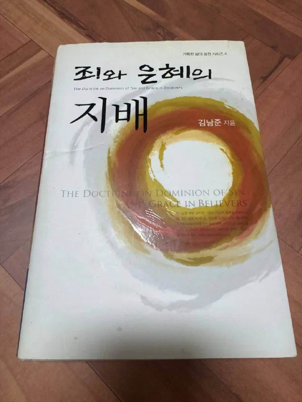 김남준 『죄와 은혜의 지배』 책 표지. &lsquo;거룩한 삶의 실천 시리즈 4&rsquo;라는 부제와 함께 붉고 노란 원형 그림이 그려져 있다